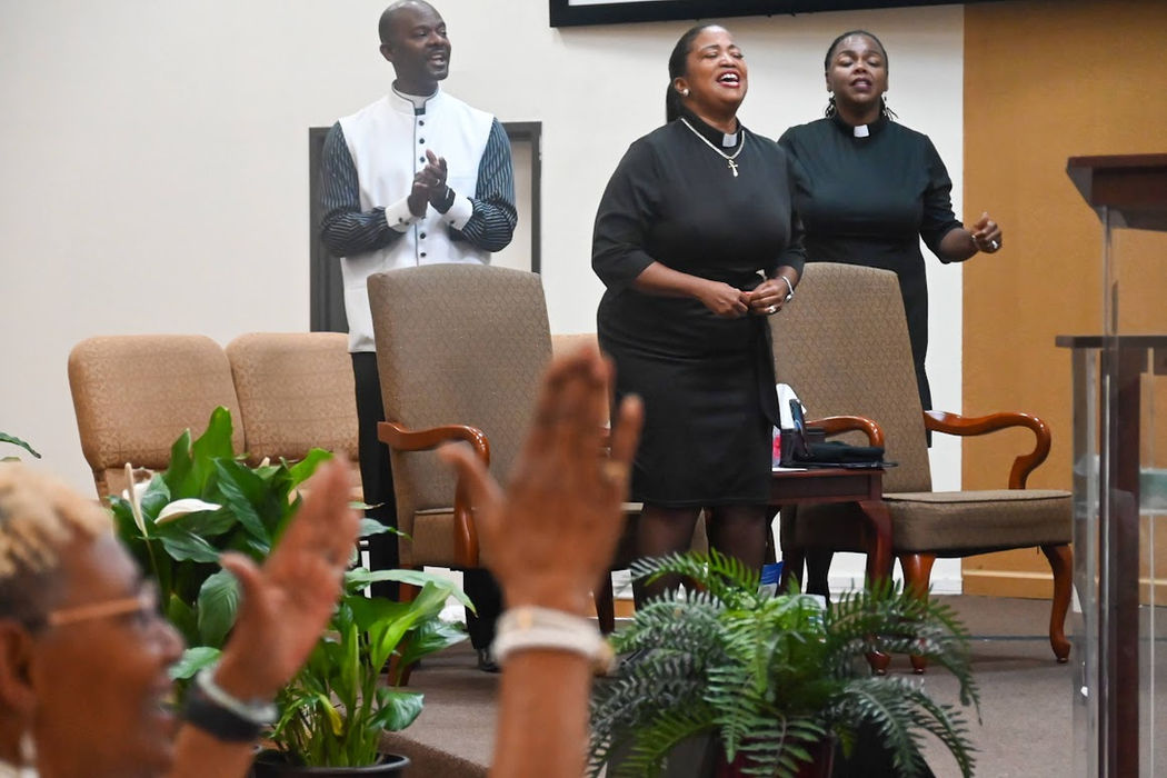Joyful choir singers and congregation clapping