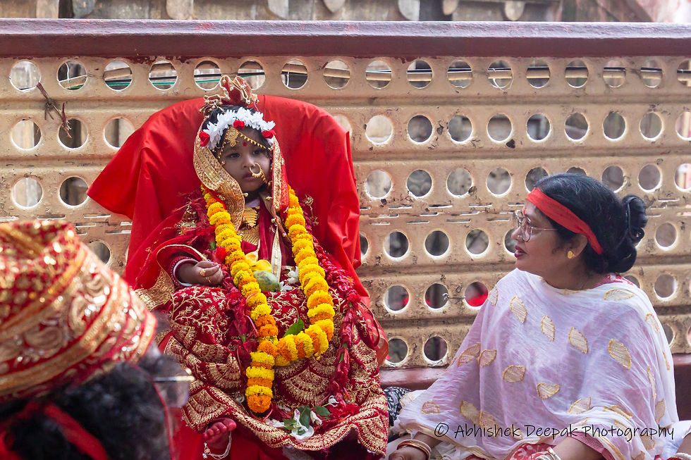 A small girl is dressed as the Goddess and some puja is performed here.