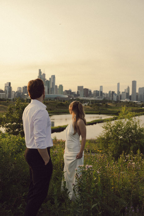 Couple overlooking a city skyline at sunset