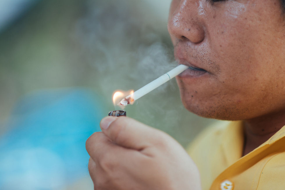 A man lighting a cigarette