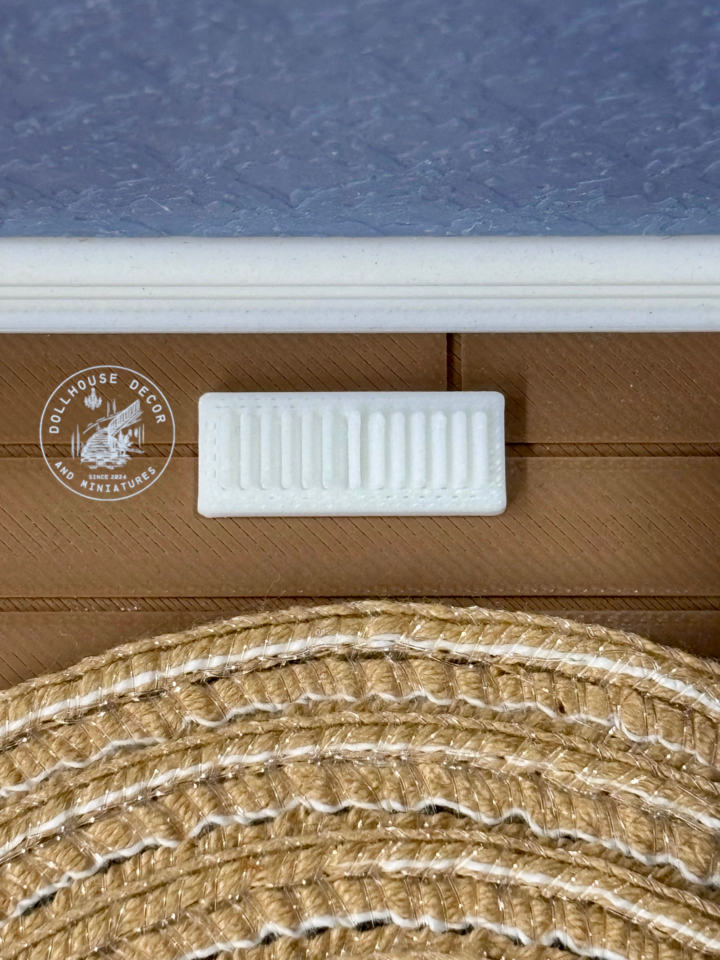 1:12 scale miniature floor air vents installed in a dollhouse floor.
