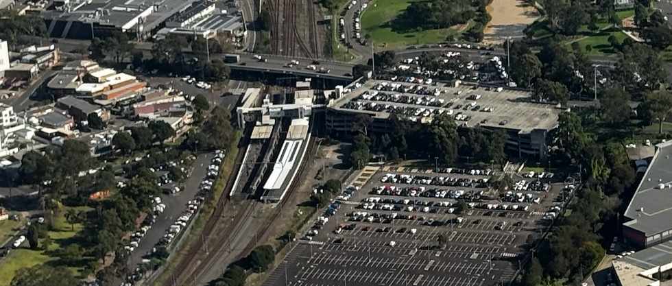 Seven Hills Train Station, identifiable as the station immediately prior to Blacktown, with a multistory and outdoor carpark immediately on the northern side