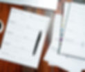DOCUMENTS BROWN DESK WITH PEN_edited.jpg