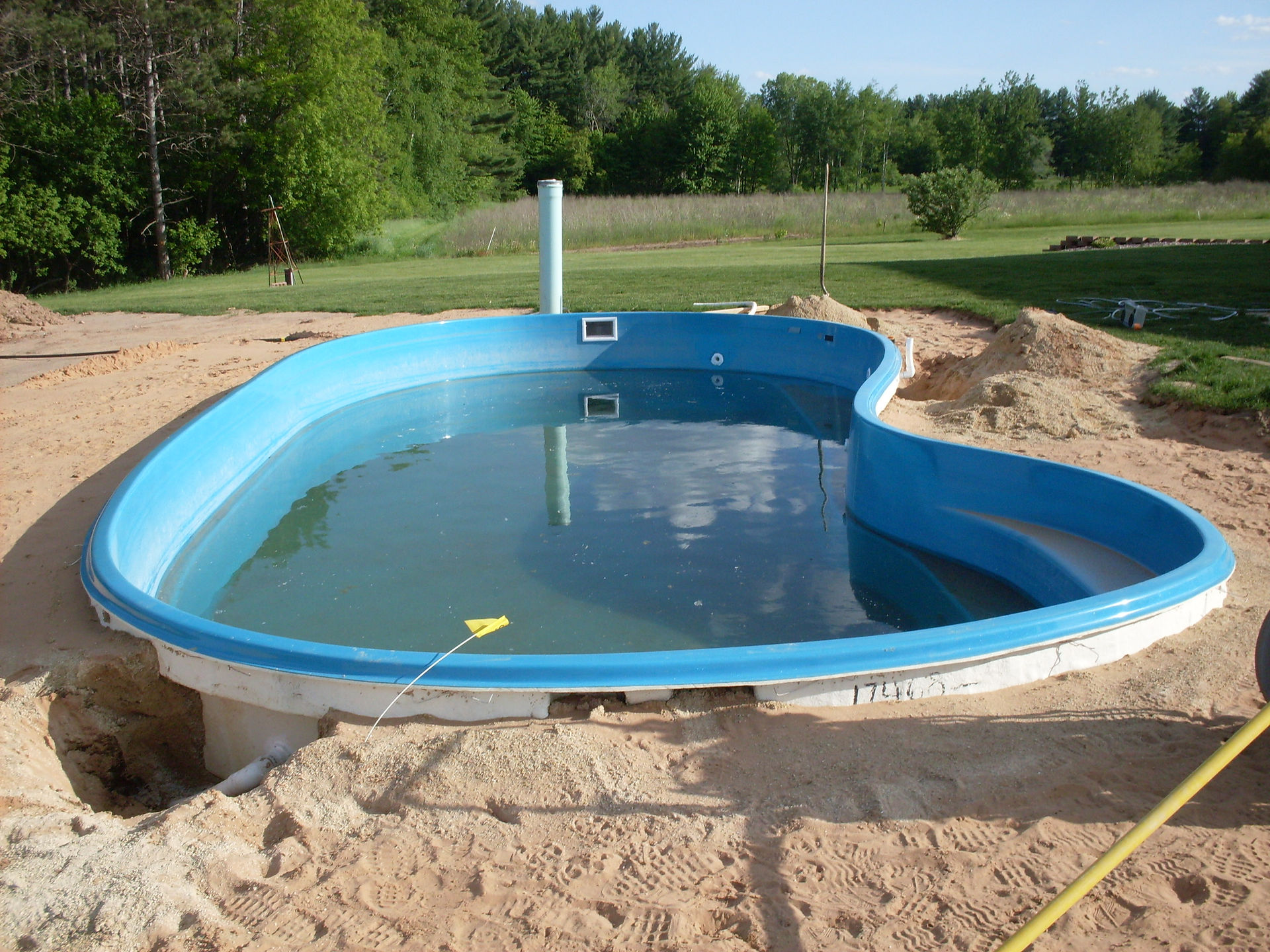 This is another fiberglass pool built by Siesta Creations. This pool was built in Shawano WI. Siesta Pools never pressure tested the plumbign and lef the homeowner with leaking fitting throuought the entire pool. All the fittings had to be removed, the pool wall sanded and new fittings installed and pressure tested.