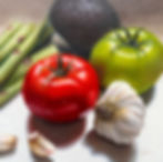 Marion Duttons final painting image of Ripened Reflections, a still life with red and green tomatoes, garlic, asparagus and avocado. Realistic Oil Painting