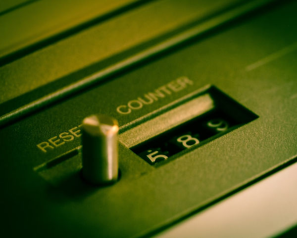 A reset counter switch next to a mechanical counter showing 589, representing the concept of a systemic reset and rebuilding of traditional structures.