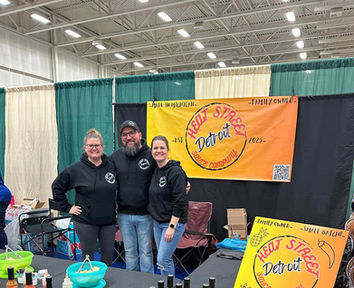 A photo of Matt, Angela, and friend at a expo.