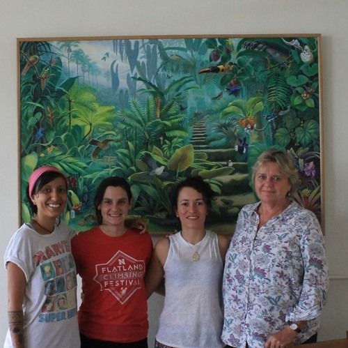 Artist Deirdre Hyde (far right) poses in front of her painting of Wilson Botanical Garden at the Las Cruces Biological Station in Costa Rica