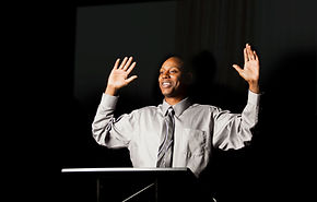 Speaker with Hands Raised