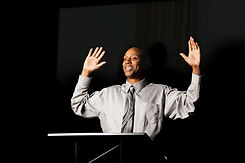 Speaker with Hands Raised