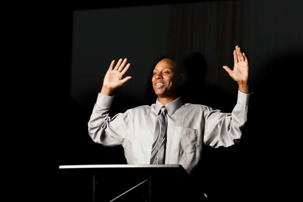 Speaker with Hands Raised