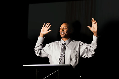 Speaker with Hands Raised