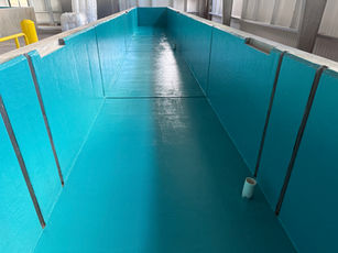 fish hatchery raceway with teal epoxy coating over the smoothly sandblasted concrete raceway