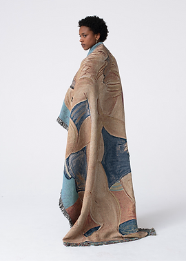 Person standing with woven blanket