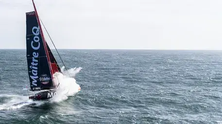 IMOCA racing yacht battling waves during the Vendée Globe