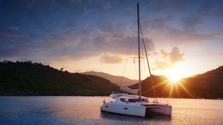 Sailboat at anchor prepared for long-term cruising with solar panels and upgraded systems