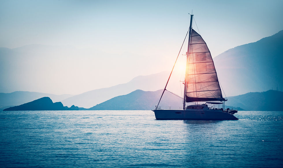 Mid-size cruising sailboat anchored in calm blue water