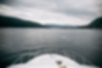 Cabin window on a sailboat covered in small water droplets on a cold winter morning.