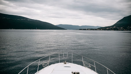 Cabin window on a sailboat covered in small water droplets on a cold winter morning.