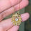 Thumbnail: Small Diamond Scallop Shell Holding A Dangling Old Cut Diamond
