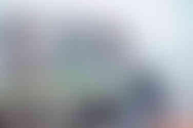 Expecting couple standing by a train bridge during a maternity shoot in Dehradun, sharing a tender moment