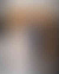 Couple adjusting hair with formal outfits and elegant background setting.