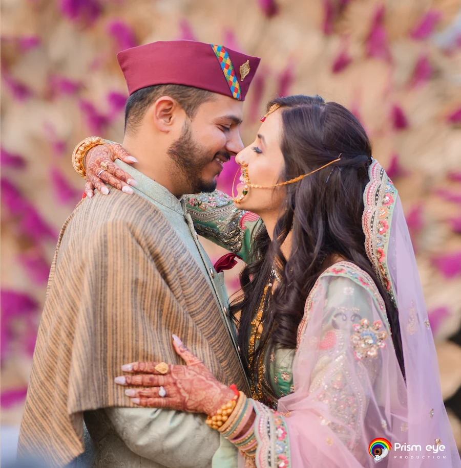 Indian wedding couple close romantic moment in traditional attire with floral background
