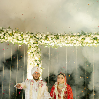 Indian couple exchanging varmala on wedding stage during traditional ceremony