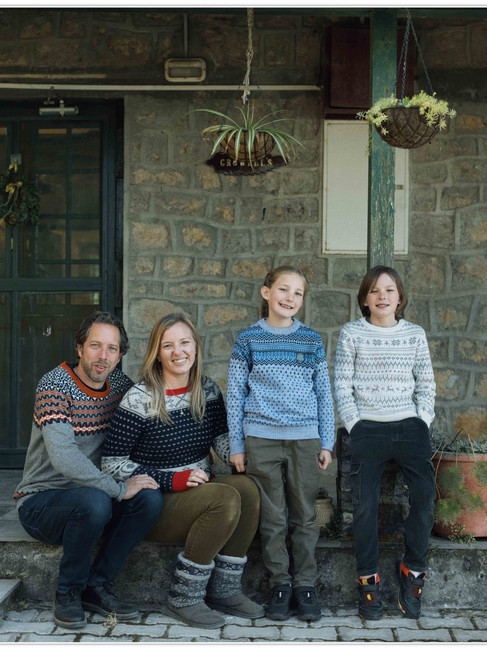 Lifestyle family portrait in Landour Mussoorie with parents and children seated together in a relaxed hill setting