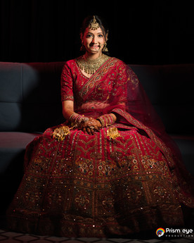 Smiling bride in red lehenga posing; Prismeyeproductions; A day in Dehradun.