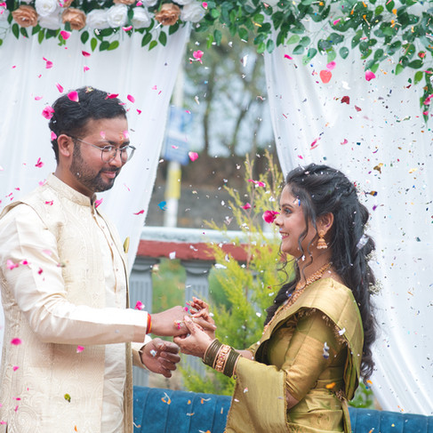 Couple's first dance surrounded by flying confetti, with motion blur creating a magical and artistic ambiance.