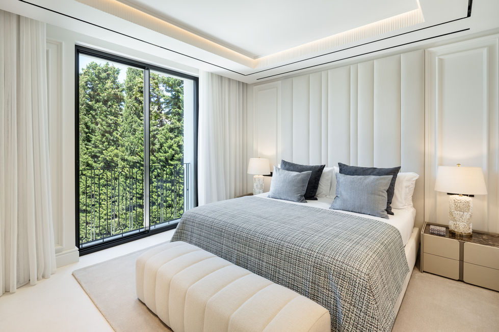 a bedroom with a large bed and a large window