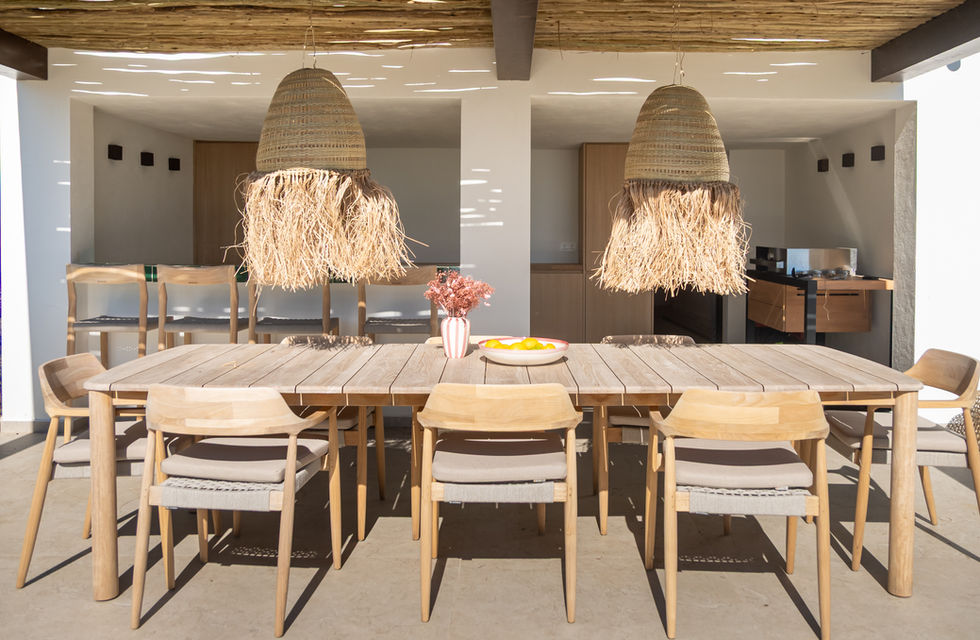 Covered pergola with a large dining table for ten guests.