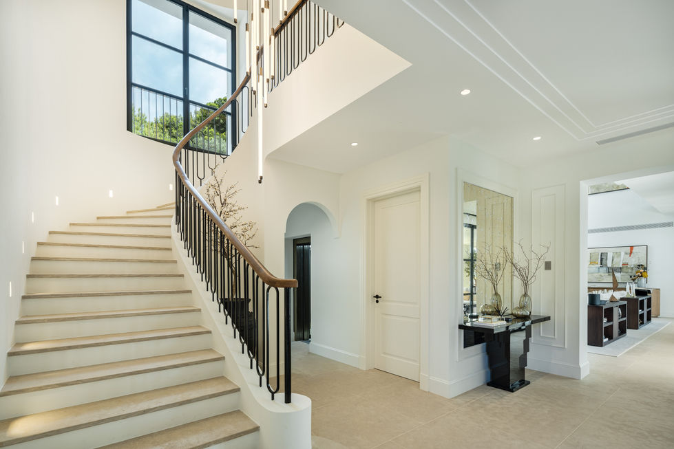 a staircase with a black railing and white steps