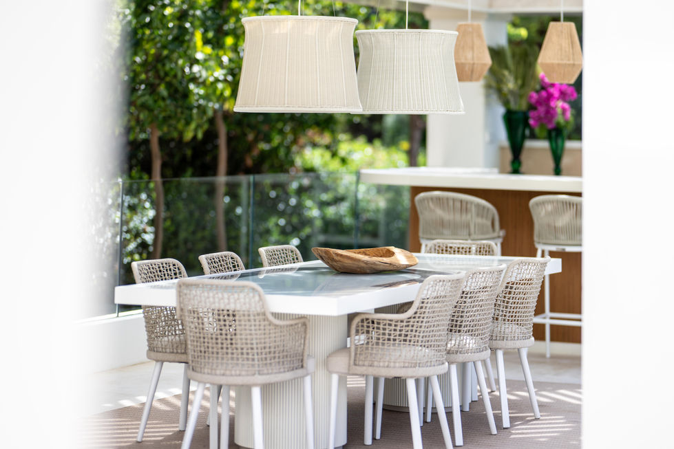 a table with chairs and a wooden bowl on it