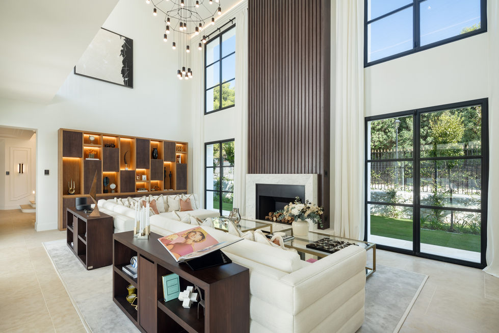 a living room with a large white couch and a fireplace