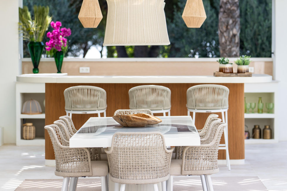 a dining room table with chairs and a bowl on it