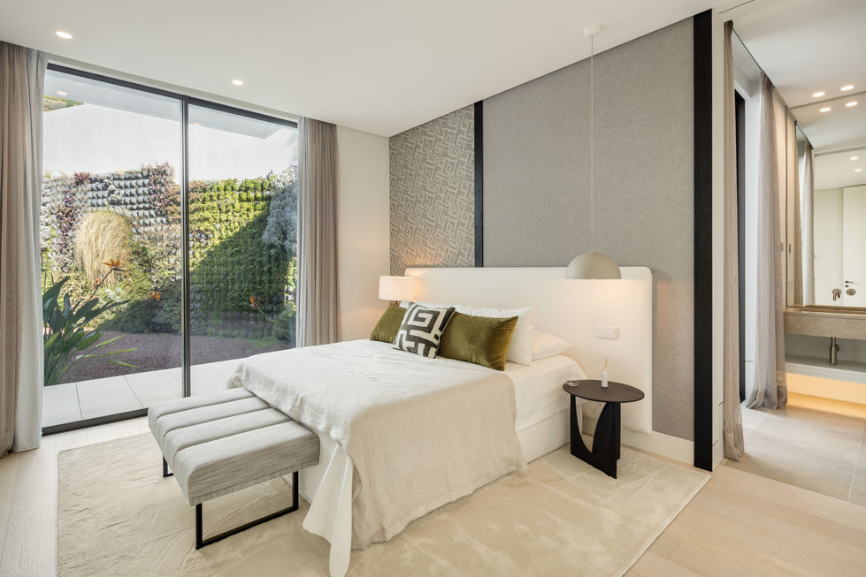 a bedroom with a large bed and a sliding glass door