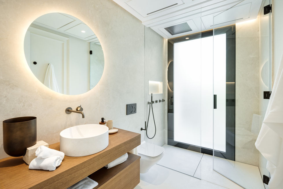 a bathroom with a round mirror and a toilet
