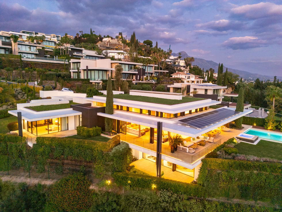 a large house with solar panels on the roof