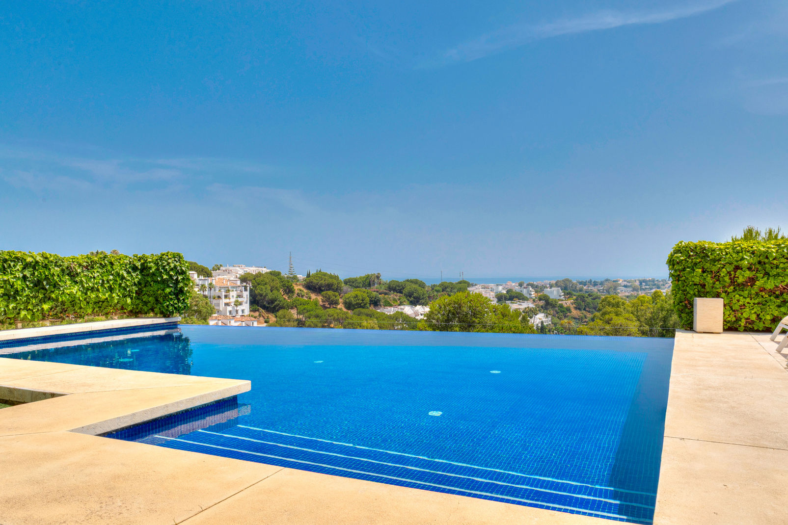 Panoramic Mediterranean Sea views from the infinity pool deck of Villa Hale Pua Hana in El Herrojo Alto, 7