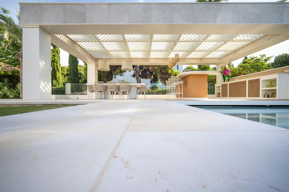 a patio with a table and chairs under a canopy