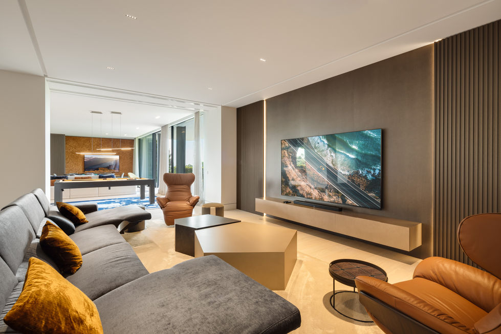 a living room with a large flat screen tv on the wall