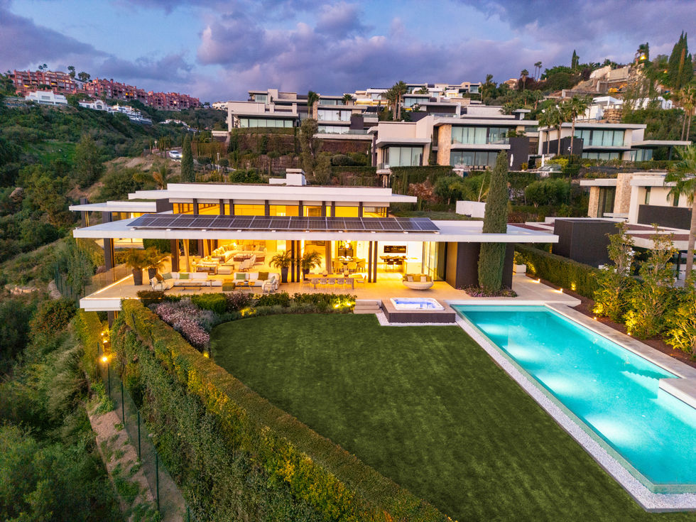 a large house with a swimming pool in front of it