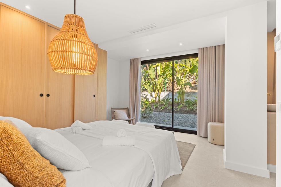 Primary bedroom with en suite bathroom and private terrace access.