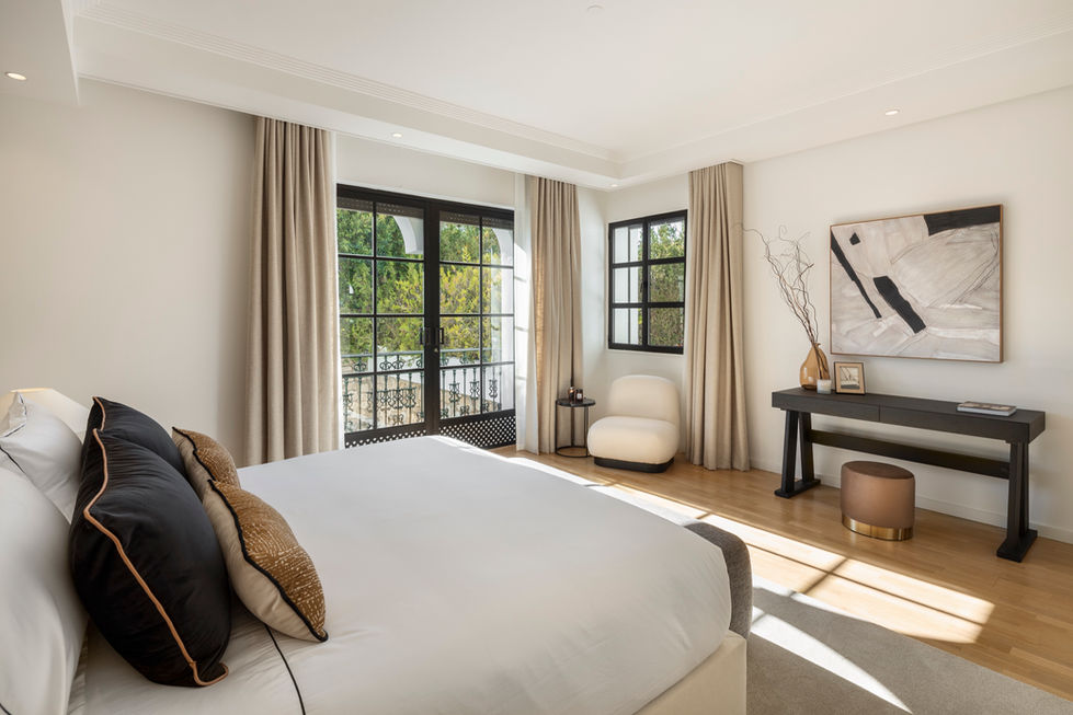 Guest Bedroom: An en-suite guest bedroom with direct access to the central patio.