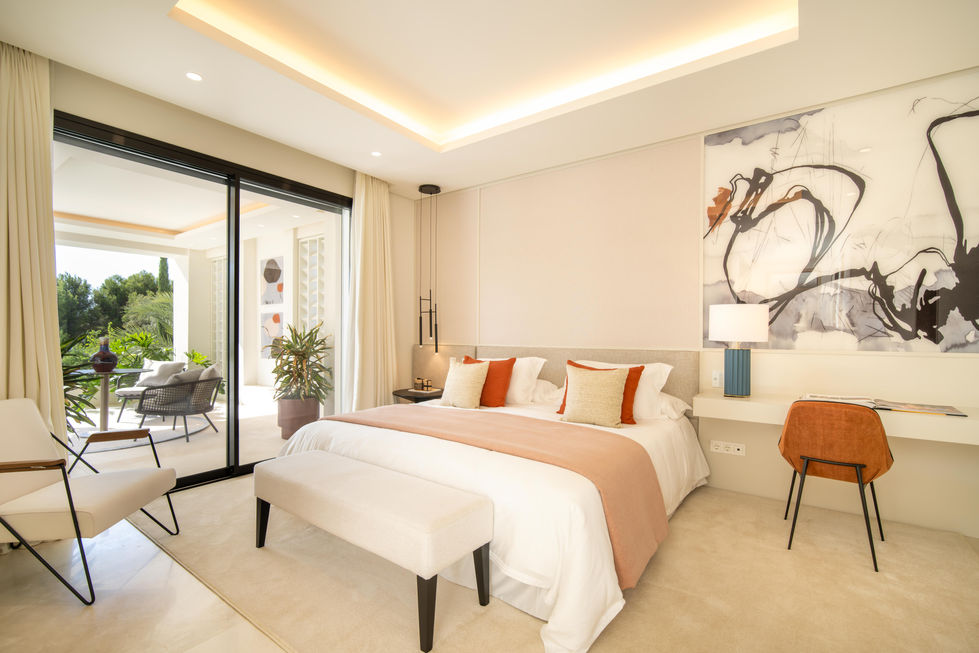 a bedroom with a large bed and a bench