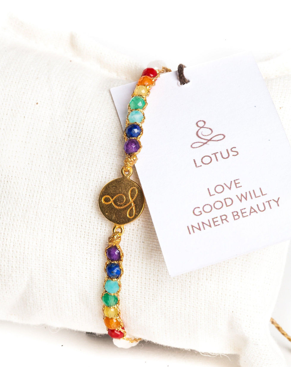 Rainbow beaded bracelet with "LOTUS LOVE GOOD WILL INNER BEAUTY" tag.