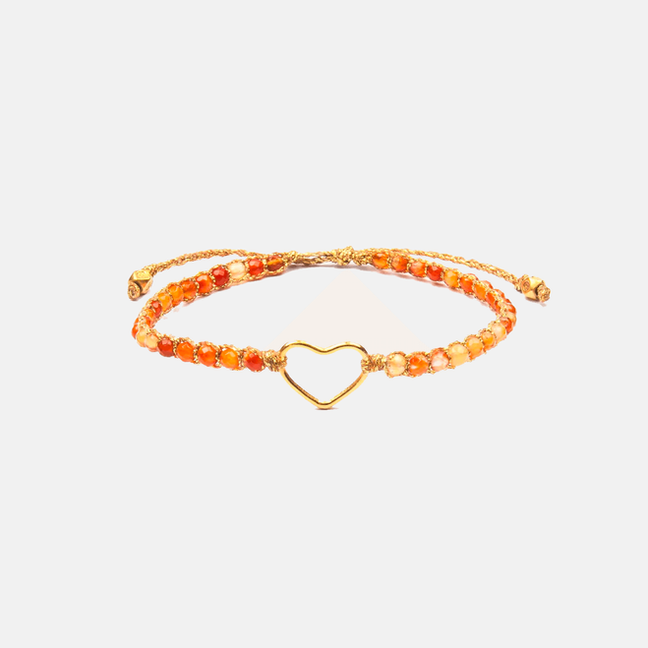 Orange beaded bracelet with a delicate gold heart charm for wrist.