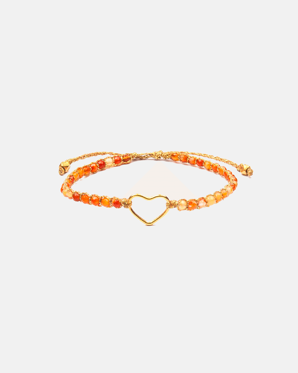 Orange beaded bracelet with a delicate gold heart charm for wrist.
